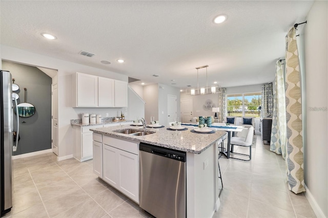 kitchen with sink, an island with sink, white cabinets, and stainless steel appliances