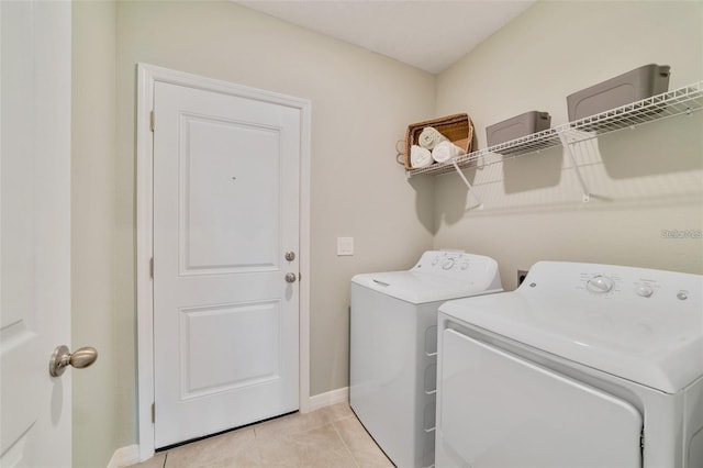 laundry area featuring light tile patterned flooring and washer and dryer