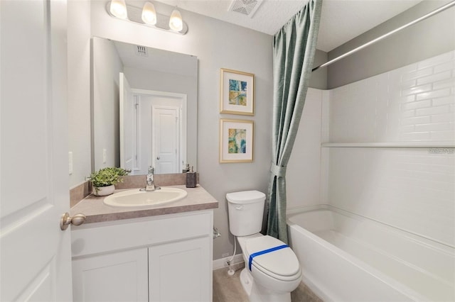 full bathroom with vanity, toilet, shower / bath combo, and a textured ceiling