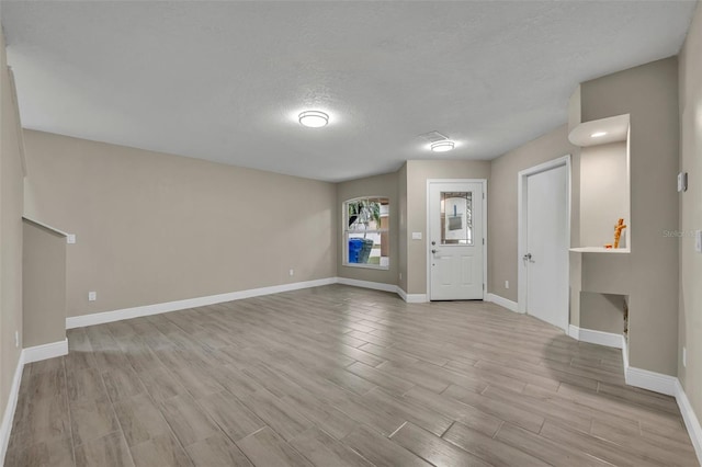 unfurnished living room with a textured ceiling