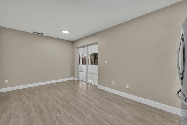 empty room with light hardwood / wood-style floors