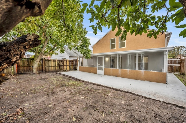 back of house featuring a sunroom and a patio