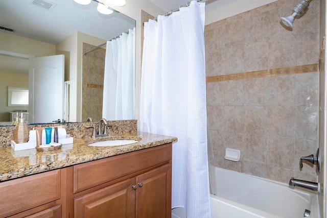 bathroom featuring vanity and shower / bath combo