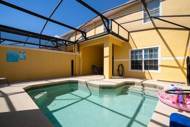 view of swimming pool with a lanai and a patio area