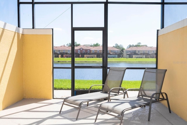 sunroom / solarium featuring a water view and a wealth of natural light