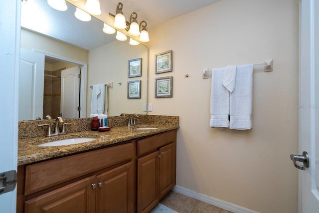 bathroom with walk in shower, vanity, and tile patterned flooring