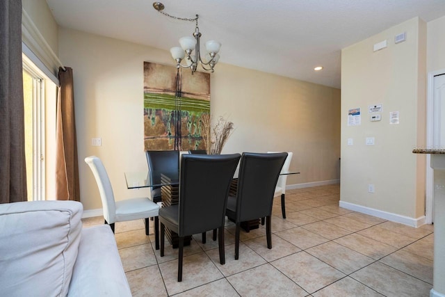 tiled dining room featuring a chandelier