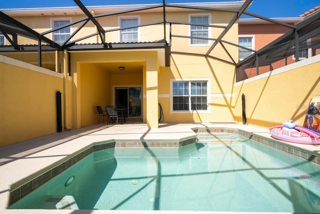 back of property featuring a lanai and a patio