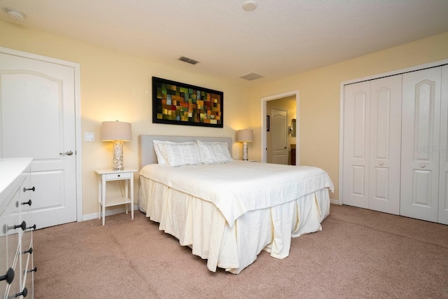 bedroom with light colored carpet and a closet