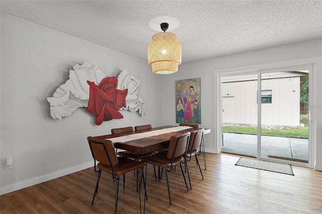 dining room with a textured ceiling and hardwood / wood-style floors