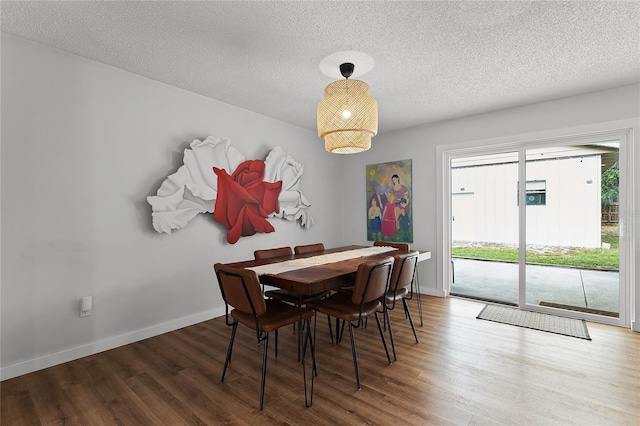 dining area featuring hardwood / wood-style floors and a textured ceiling