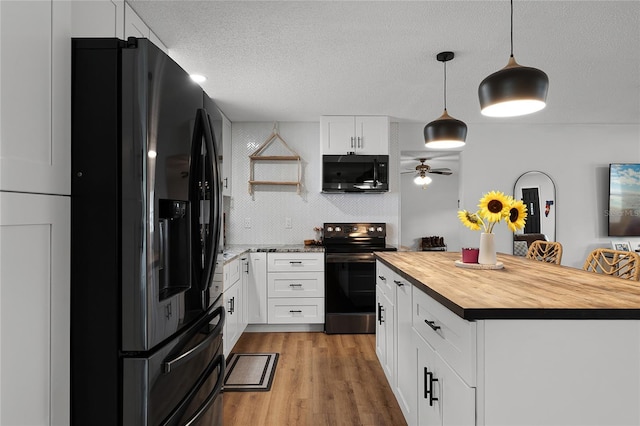 kitchen featuring a center island, pendant lighting, range with electric stovetop, fridge with ice dispenser, and white cabinets