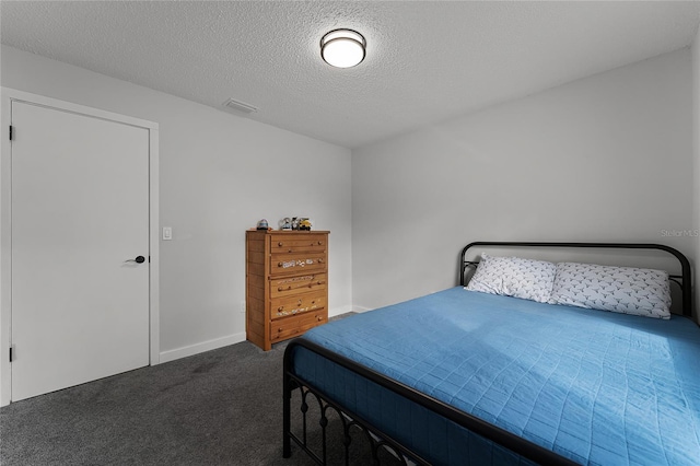 bedroom with a textured ceiling and carpet flooring