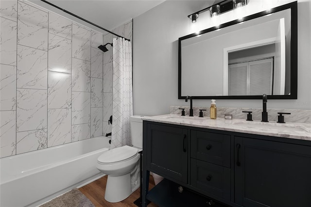 full bathroom with hardwood / wood-style floors, toilet, vanity, and shower / bathtub combination with curtain