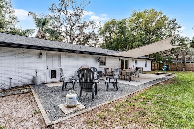 back of property featuring a lawn and a patio area