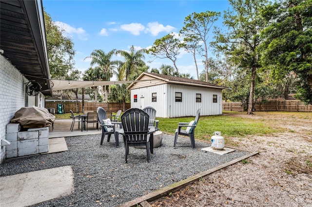 view of patio featuring an outbuilding and an outdoor fire pit