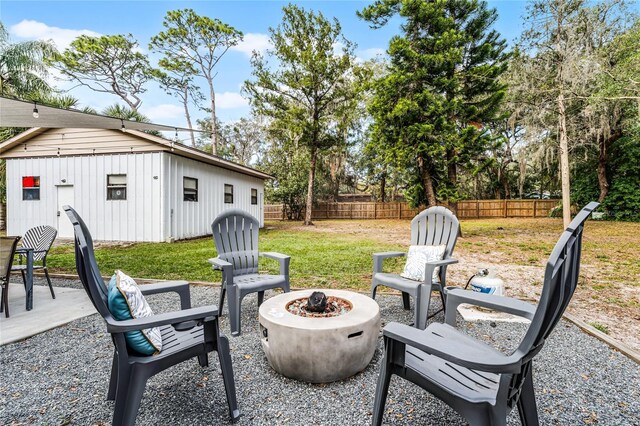 view of yard with a patio area, a fire pit, and an outdoor structure