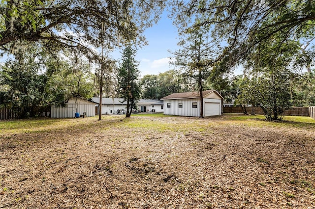 view of yard with a garage and a storage unit