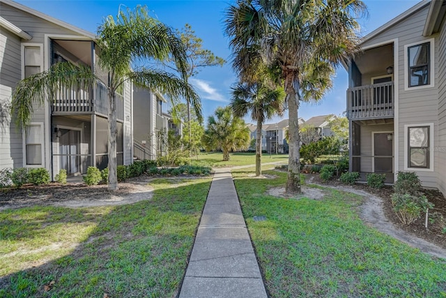 view of home's community with a yard