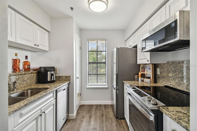 kitchen featuring sink, white cabinetry, and stainless steel appliances