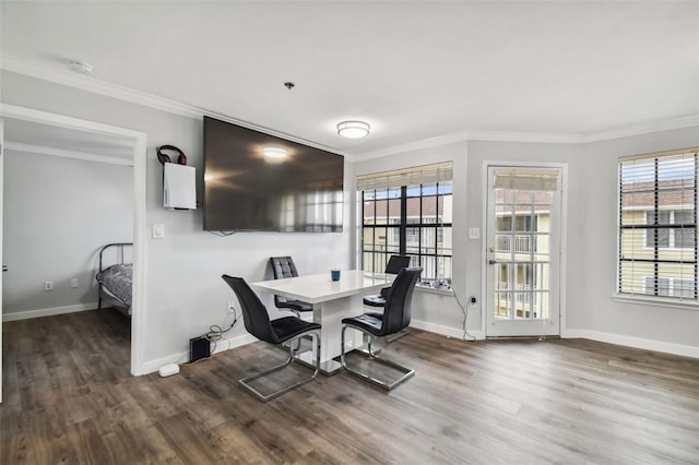 dining area featuring a healthy amount of sunlight, dark wood-type flooring, and ornamental molding