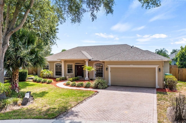 ranch-style house with a garage and a front lawn