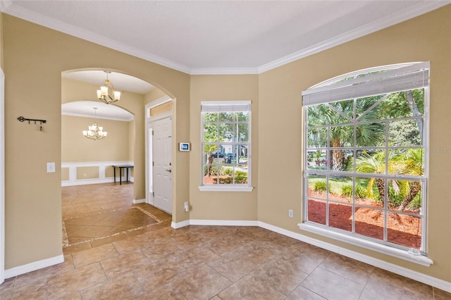 foyer featuring a notable chandelier and crown molding