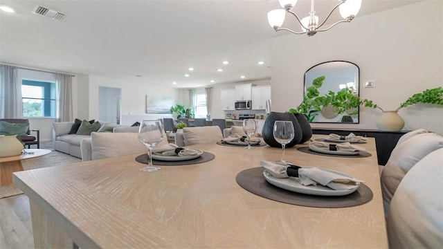 dining area with a wealth of natural light and a chandelier