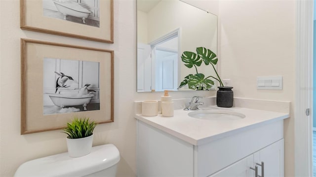 bathroom featuring toilet and vanity