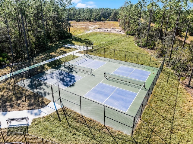 view of sport court featuring a lawn