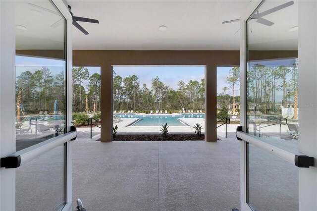 exterior space featuring a community pool and ceiling fan