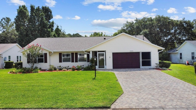 ranch-style home featuring a garage and a front yard