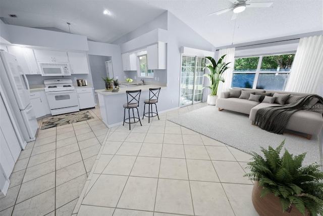 tiled living room featuring vaulted ceiling, sink, and ceiling fan