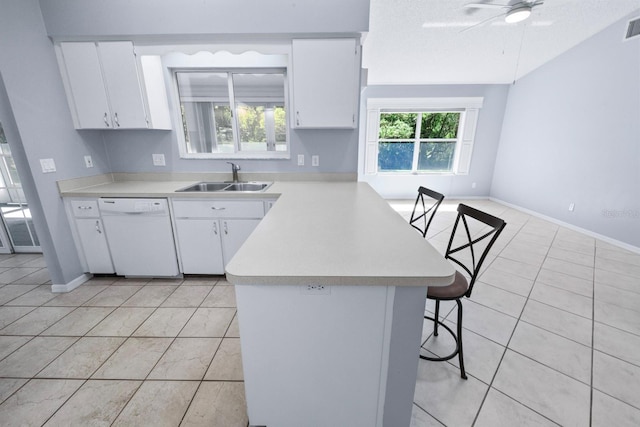 kitchen featuring white cabinetry, sink, a breakfast bar area, and white dishwasher