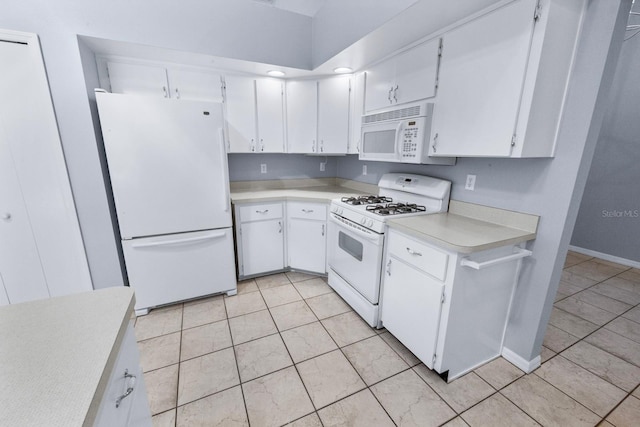 kitchen featuring white cabinetry, light tile patterned floors, and white appliances