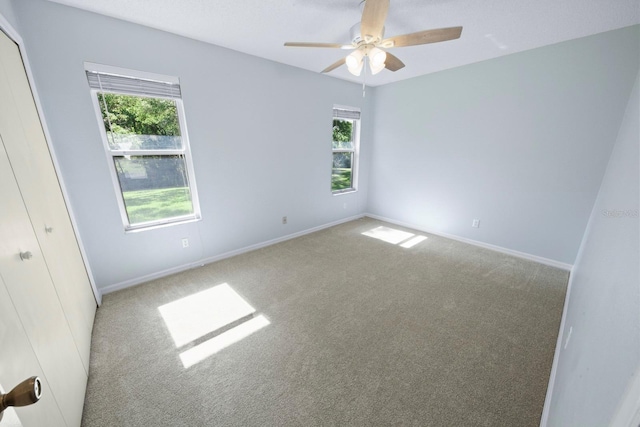 empty room with carpet and ceiling fan