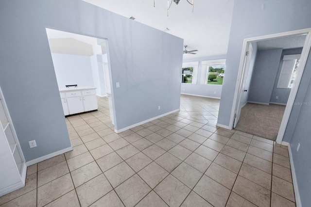 empty room featuring light tile patterned floors and ceiling fan