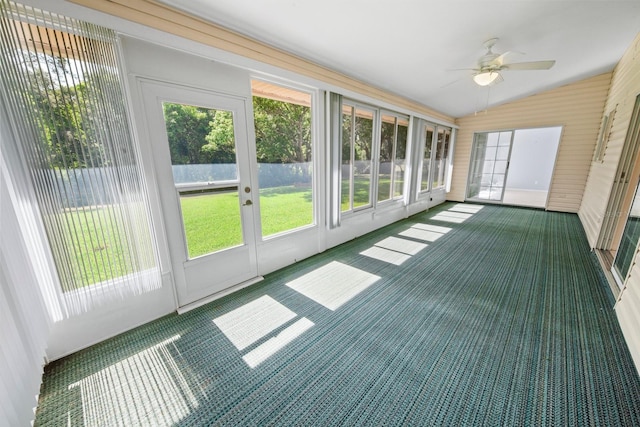 unfurnished sunroom with ceiling fan, plenty of natural light, and lofted ceiling