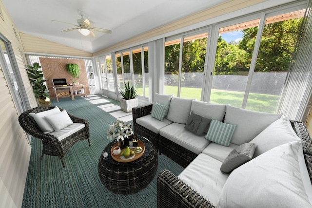 sunroom with ceiling fan, vaulted ceiling, and a wealth of natural light