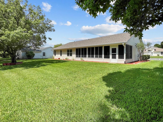 rear view of property with a yard