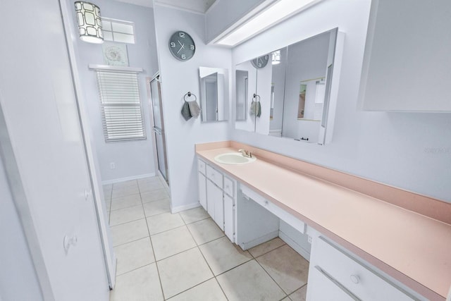 bathroom with walk in shower, tile patterned floors, and vanity