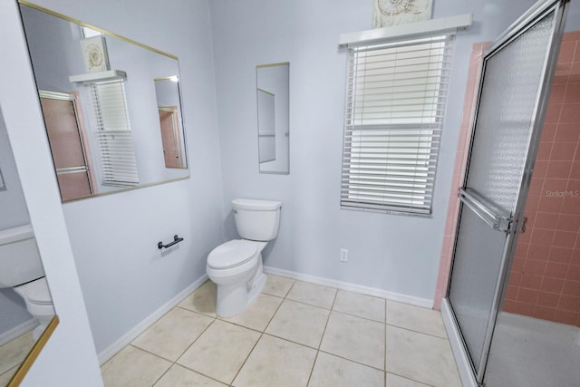 bathroom with walk in shower, tile patterned floors, and toilet