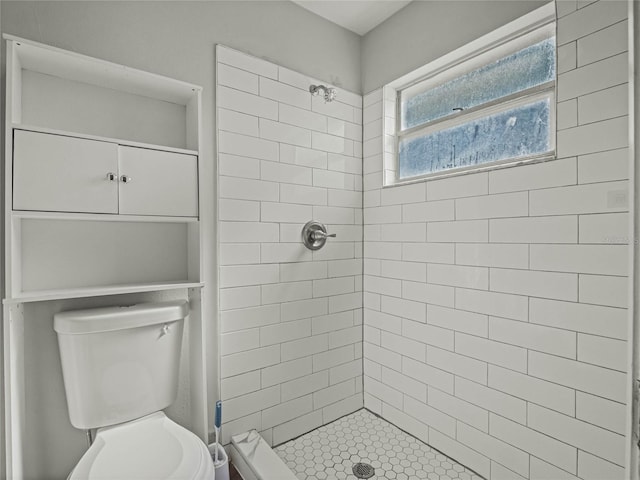 bathroom with toilet and tiled shower