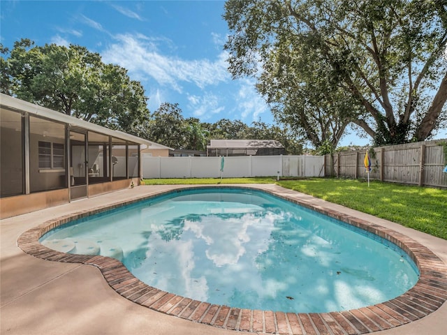 view of swimming pool featuring a yard, a fenced backyard, and a sunroom