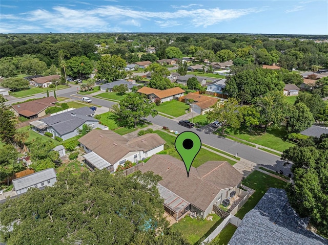 drone / aerial view with a residential view and a view of trees