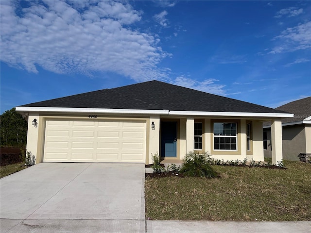 view of front of house with a front lawn and a garage