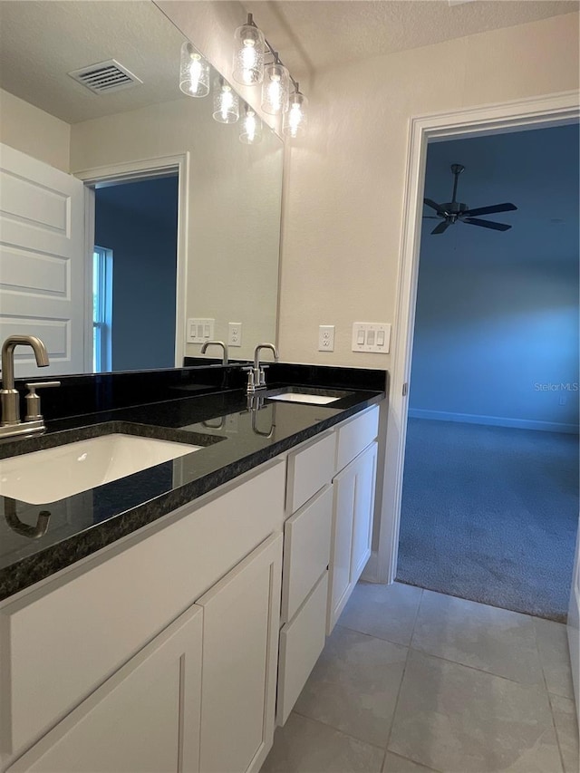 bathroom with a textured ceiling, ceiling fan, tile patterned floors, and vanity