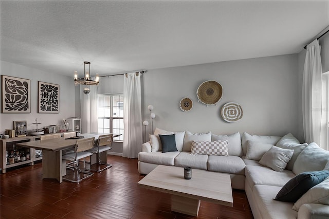 living room featuring a textured ceiling and an inviting chandelier