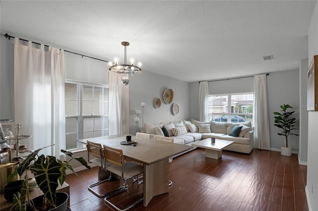 living room with an inviting chandelier and dark hardwood / wood-style floors