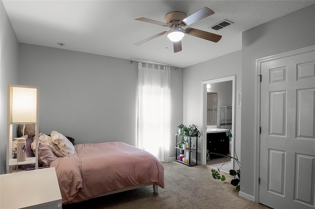 bedroom featuring ceiling fan, carpet, and ensuite bath